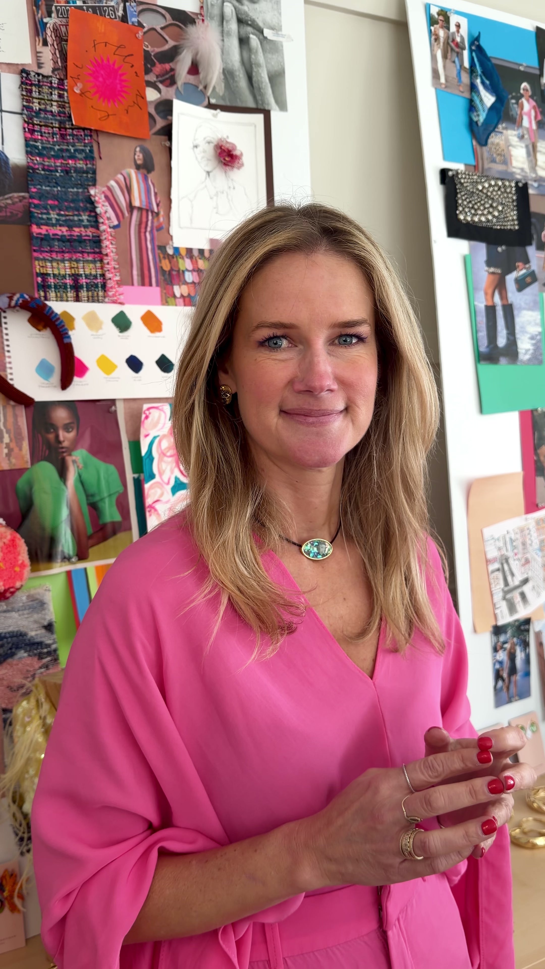 Model wearing pink top with gold stud earrings and iridescent green choker necklace