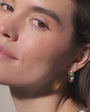 Model wearing semi precious stone and gold huggie hoop. 