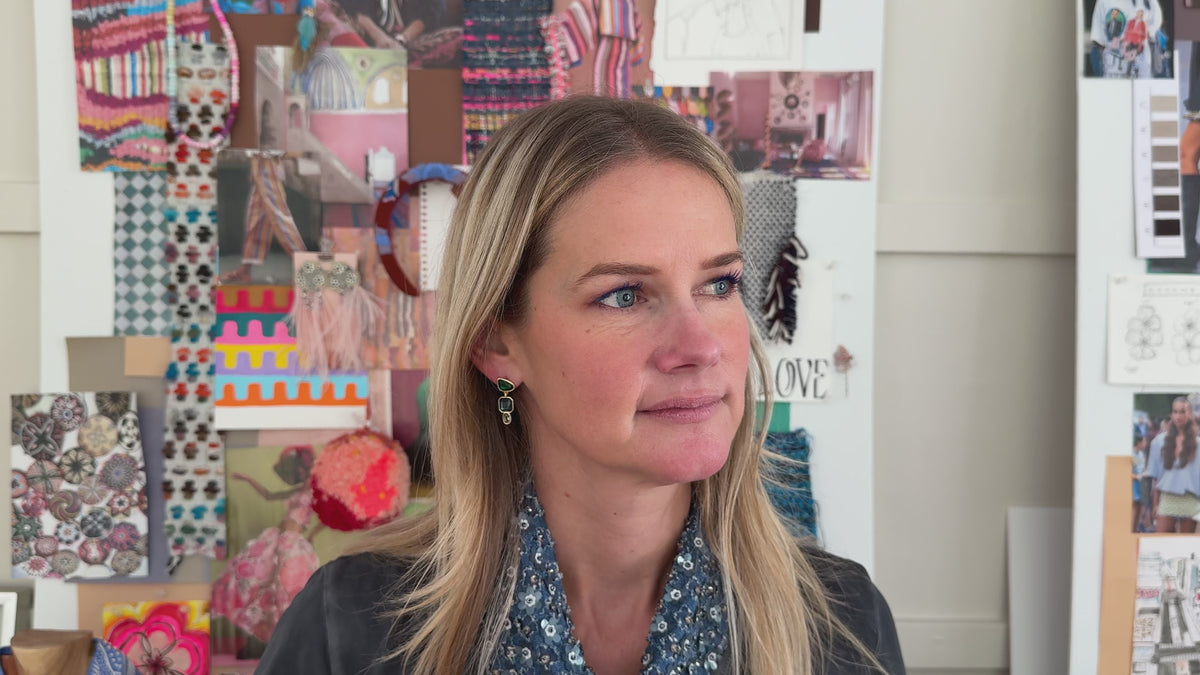 Gold-tone drop earrings featuring faceted green, blue, and clear rectangular stones in a geometric design on Mignonne Gavigan video