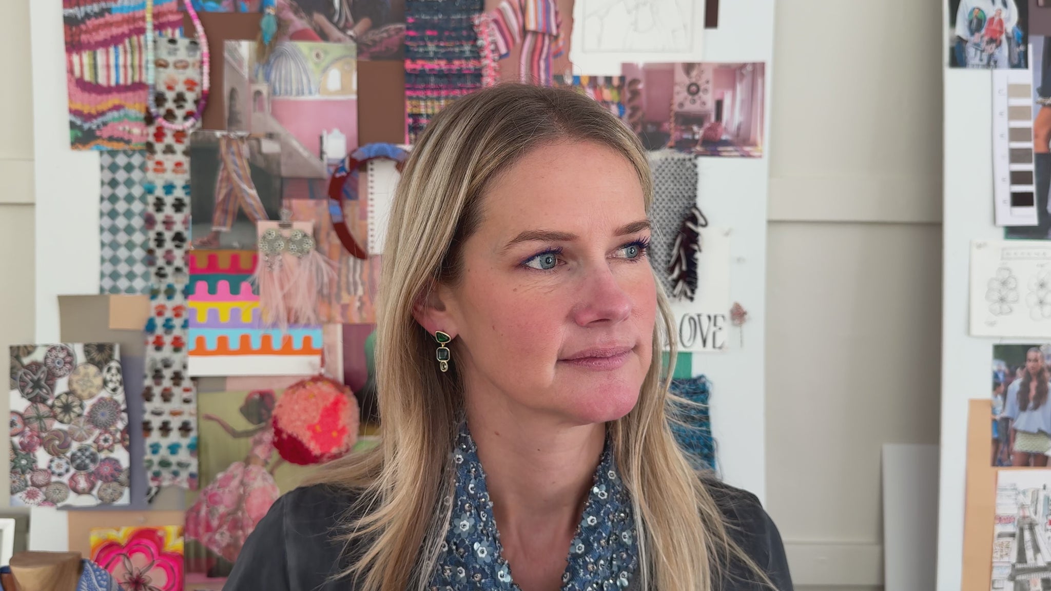 Gold-tone drop earrings featuring faceted green, blue, and clear rectangular stones in a geometric design on Mignonne Gavigan video