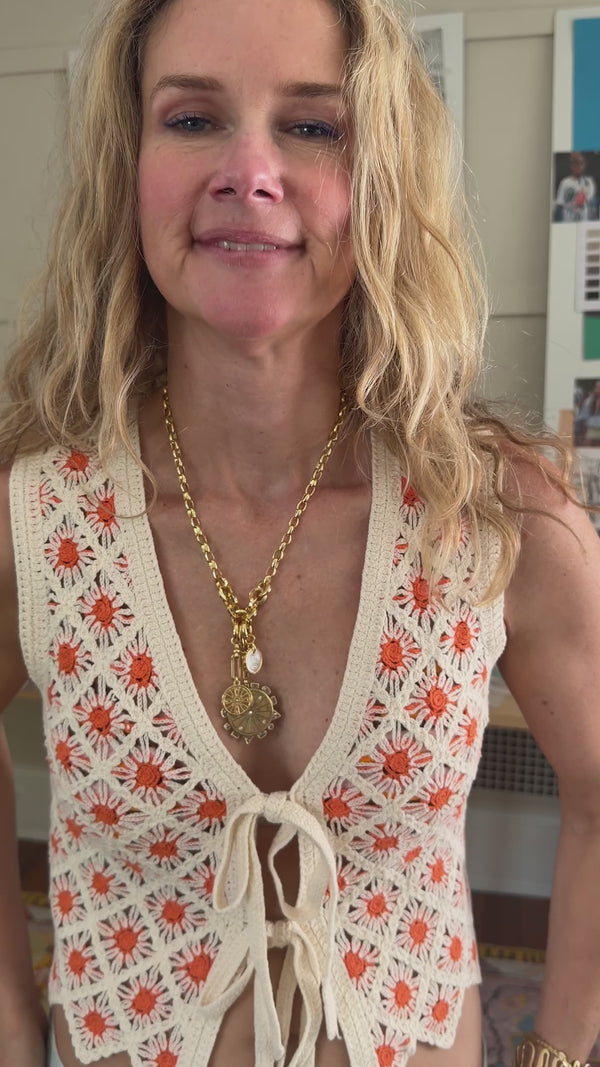 Model showing how you can add a mother of pearl charm to a necklace called the voyager