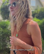 Model wearing the green and gold chain link odyssey necklace while walking down the street
