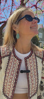 Model outside wearing turquoise shell shaped drop earring 