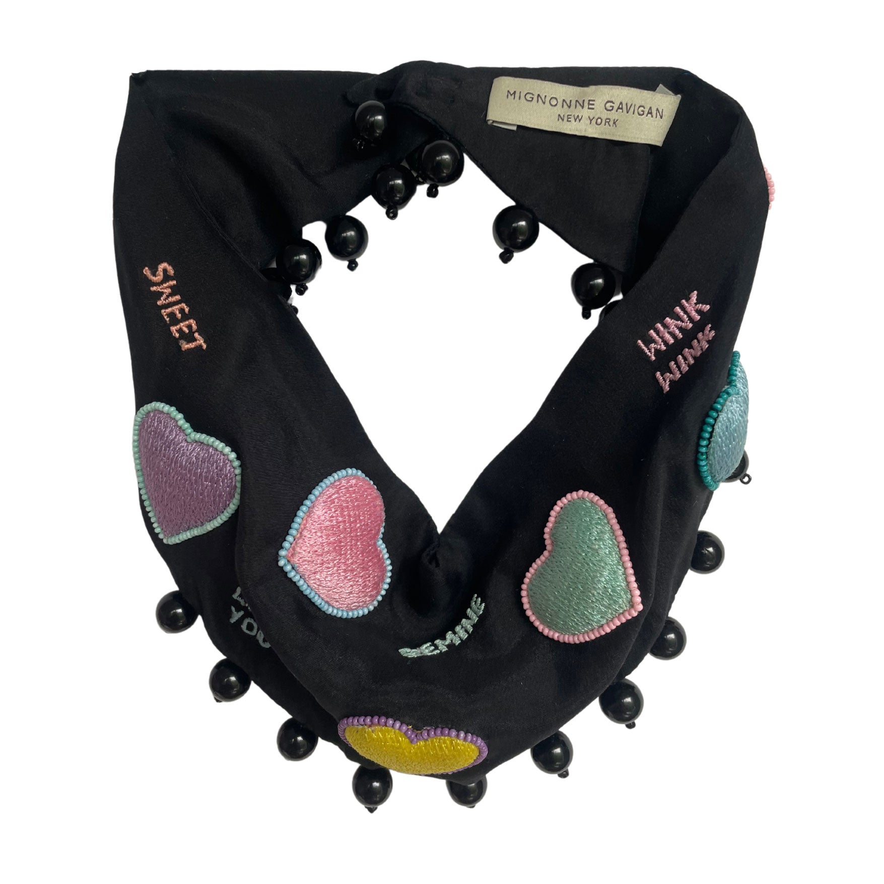 Black scarf with colorful heart patterns and black beads, branded 'Mignonne Gavigan'.