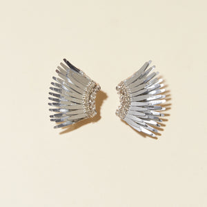 Metallic Silver Wing Stud Earrings on Cream Background