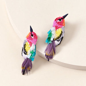 Multi-Colored Feather and Bead Bird Earrings on Tan Background