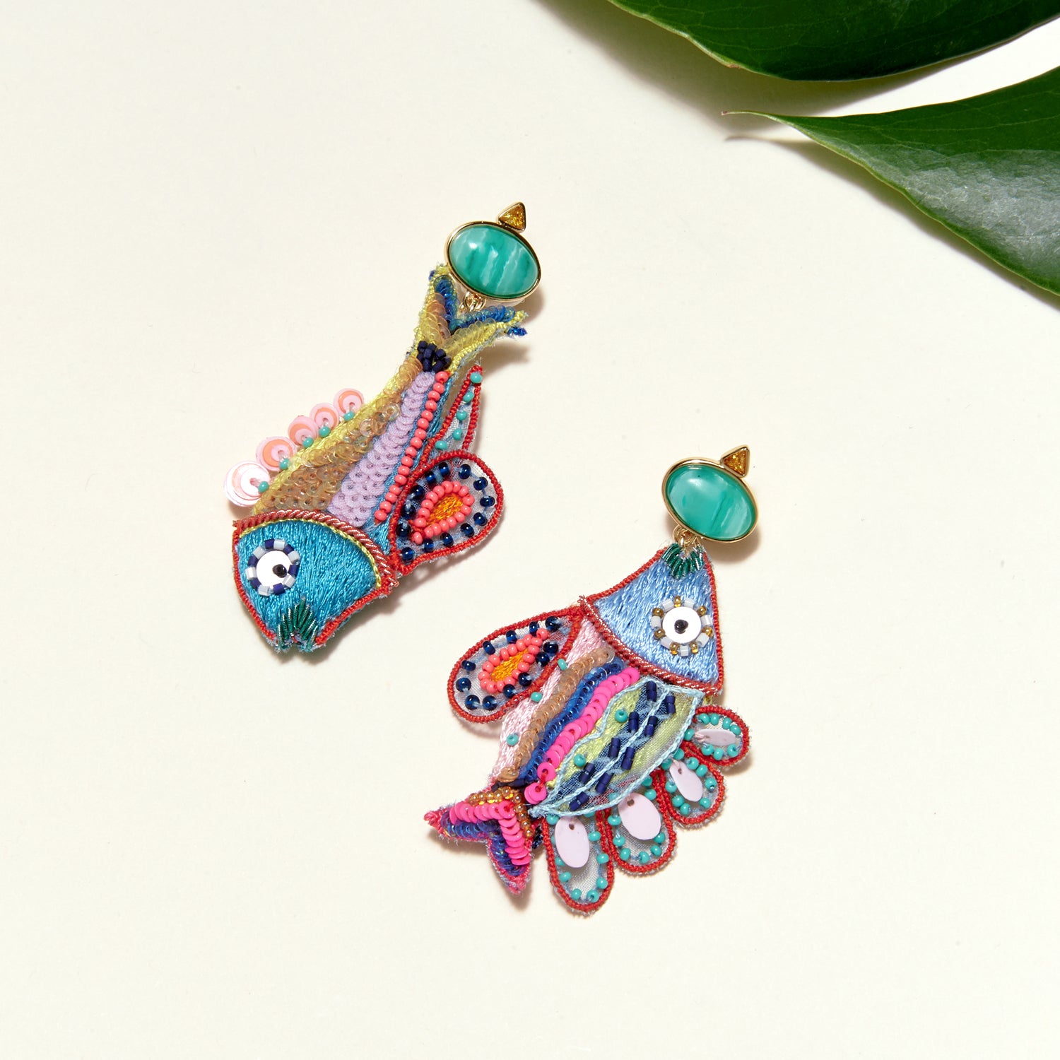 Multi-Colored Beaded and Embroidered Fish Drop Earrings on Tan Background