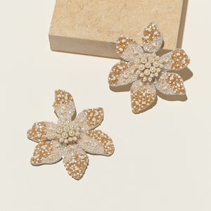 Cream and Tan Bead and Pearl Flower Drop Earrings Staged with Stone on Cream Background