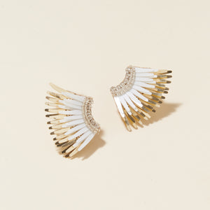 White Gold Sequin Wing Stud Earrings on Cream Background